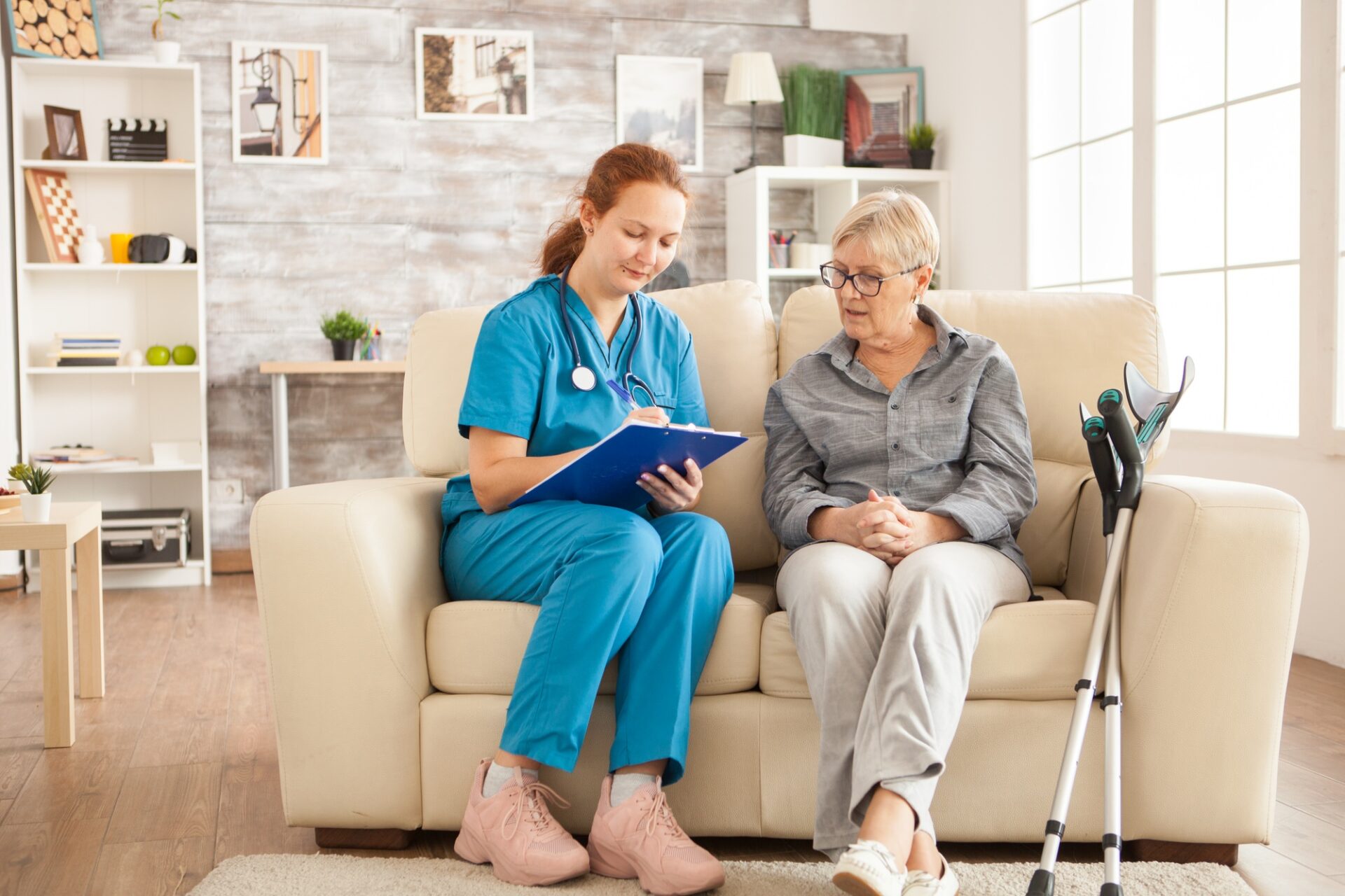 Female nurse writing on clipboard