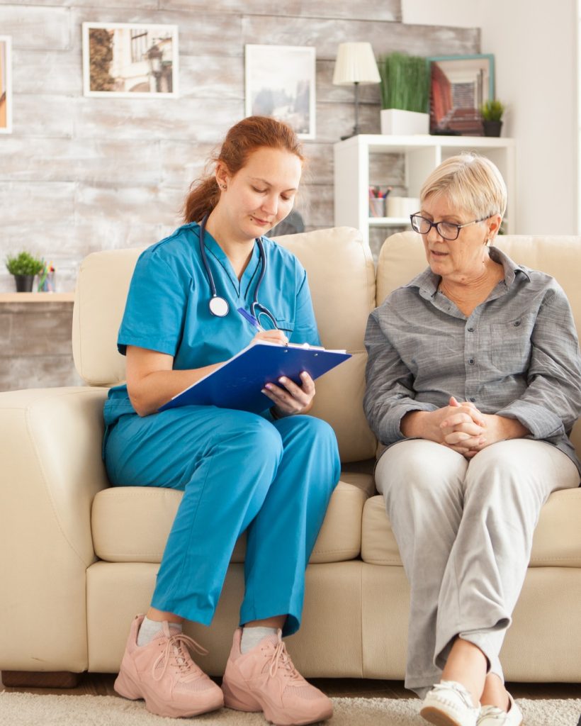 Female nurse writing on clipboard Female nurse writing on clipboard