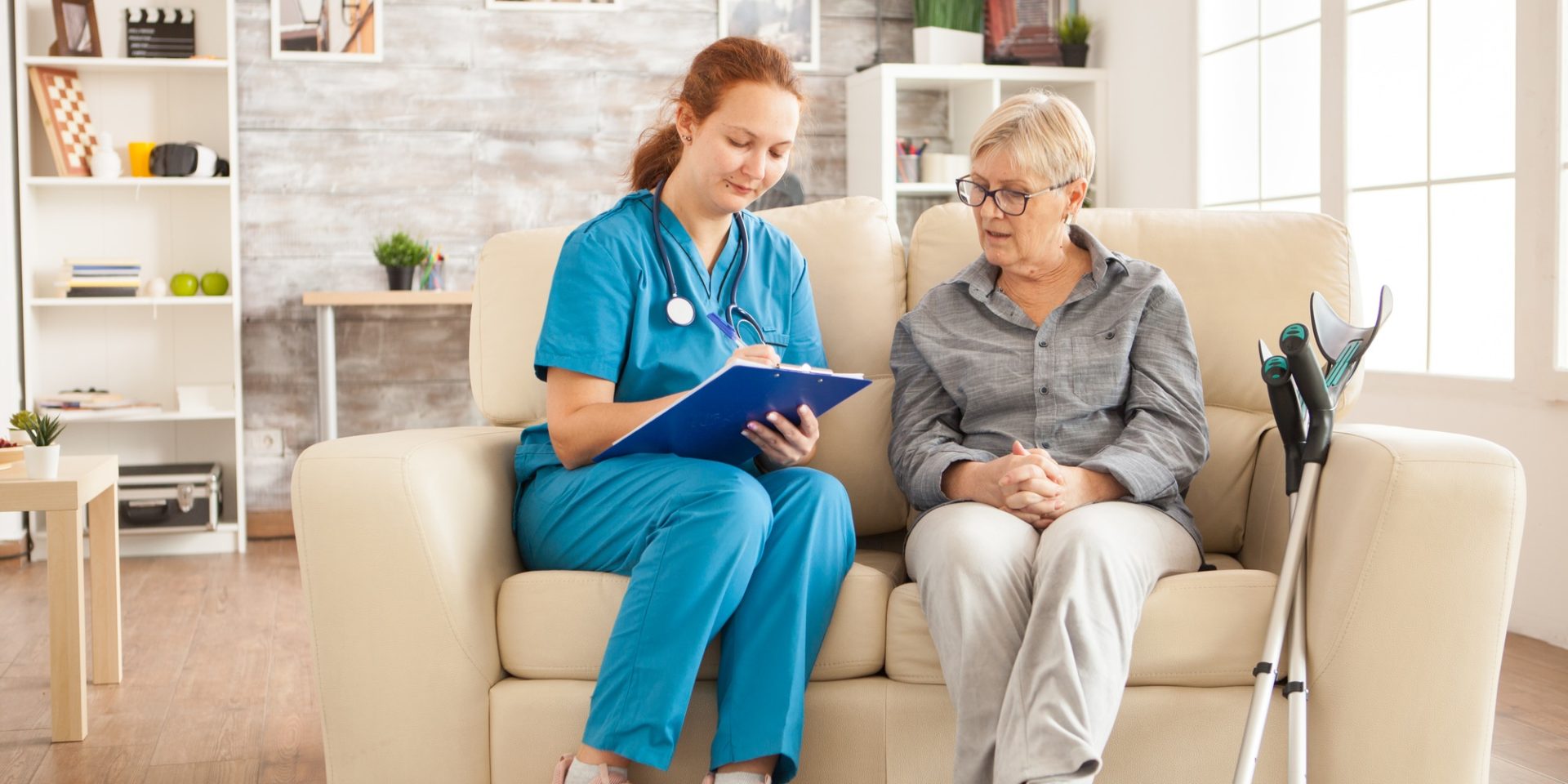 Female nurse writing on clipboard
